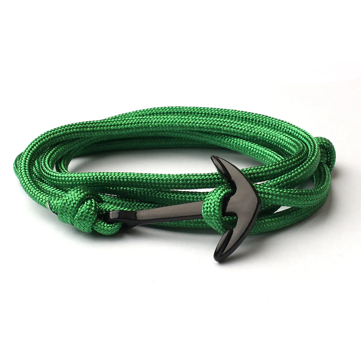 Green braided bracelet with a black anchor clasp on a white background