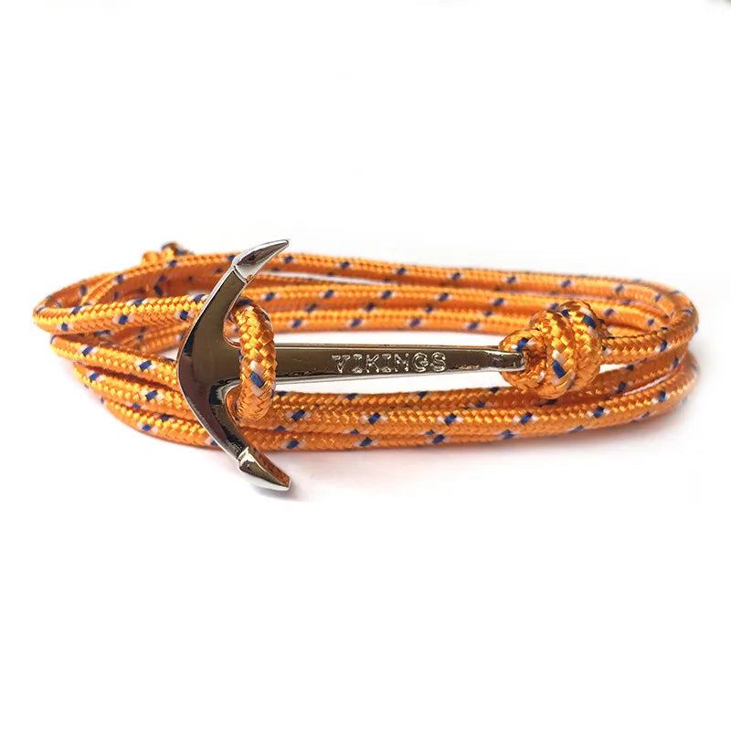 Orange and blue braided bracelet with a silver anchor charm on a white background
