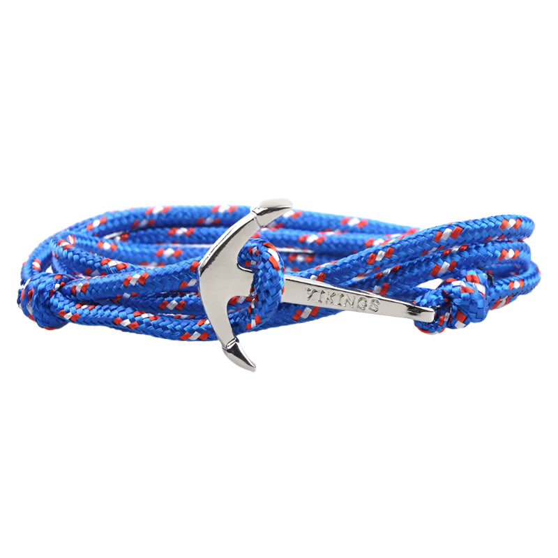 Blue and red braided bracelet with a silver anchor charm on a white background.